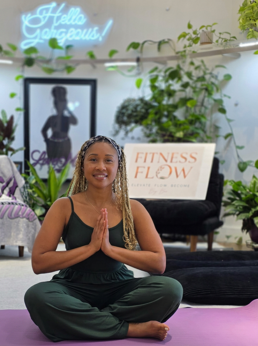 Bo, founder of Fitness Flow, seated calmly in a bright yoga studio